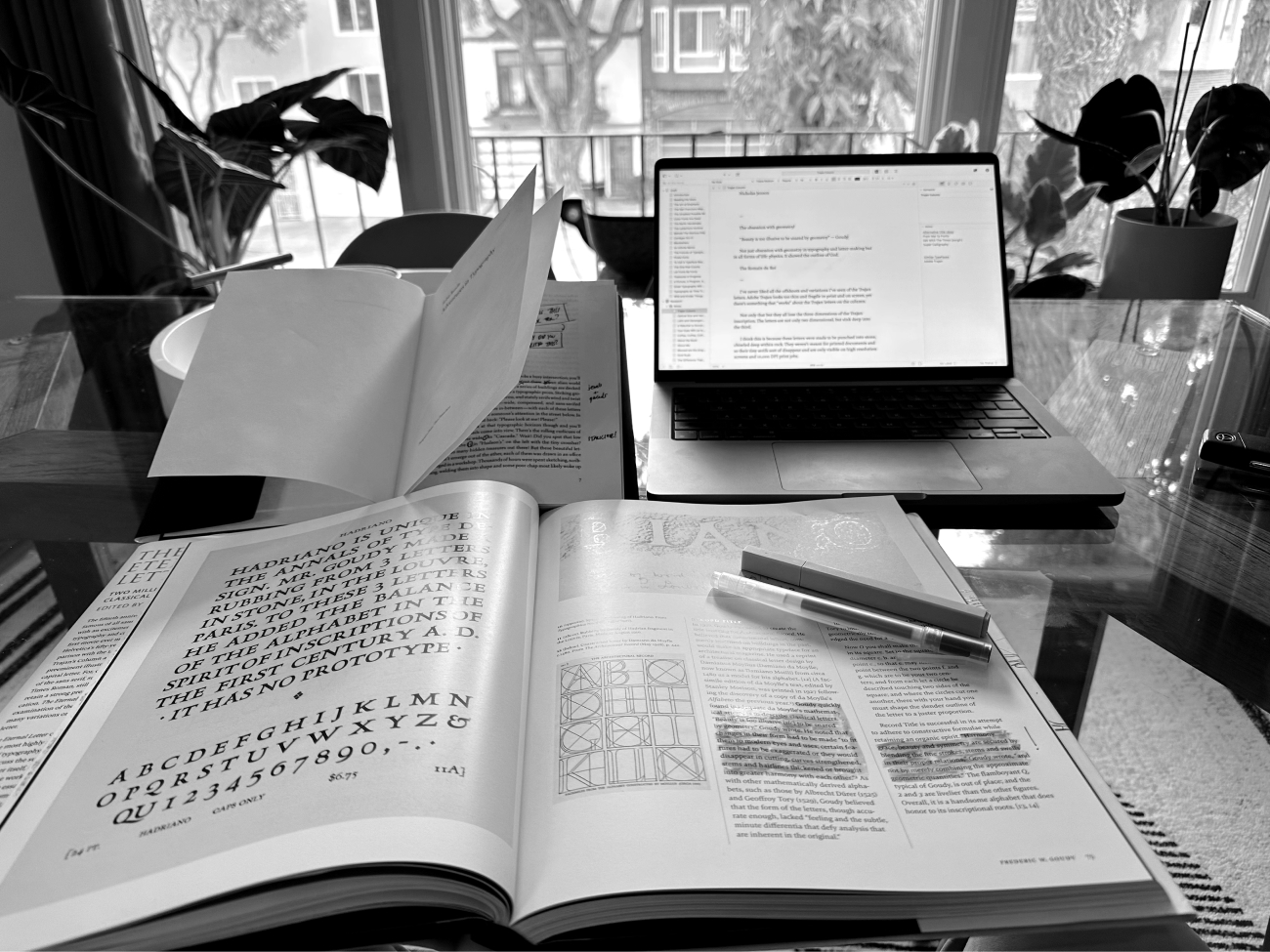 A photograph of my desk with books open and notes scribbled in the margins